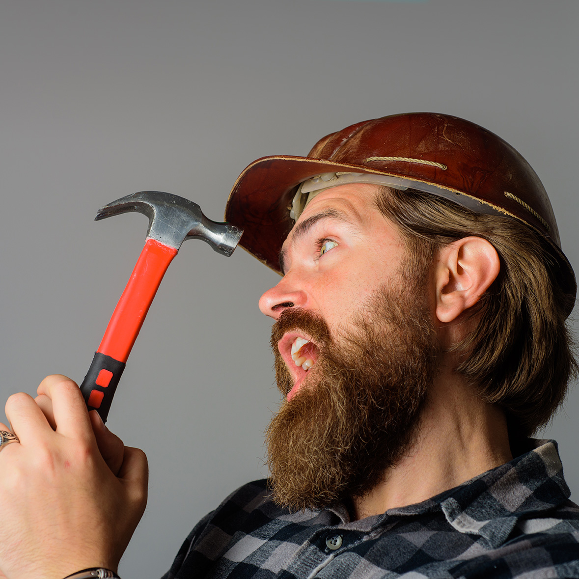 Repairment. Mechanical worker. Worker with hammer. Builder in hardhat. Portrait of bearded workman. Building, industry, technology. Builder in hard hat. Advertise